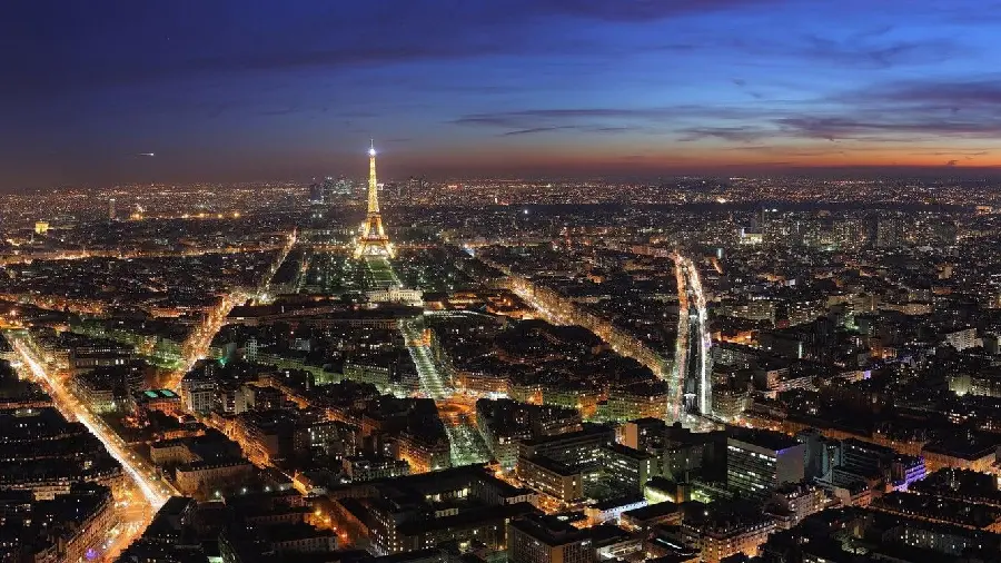 Download an interesting background of the main and side streets and the Eiffel Tower in the dark of the night in Paris, the French Cultural Center