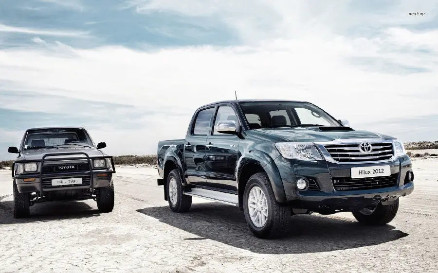 Download HD Color Collage Wallpaper of Two Black Toyota Hiluxes on Dry Road and Sunny Sky