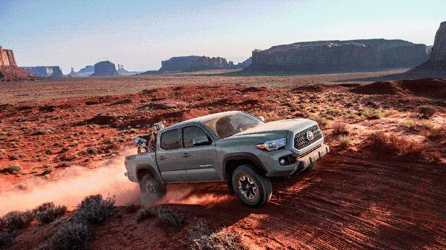 Download a prominent stock image of a Toyota Tacoma suitable for roads and paths