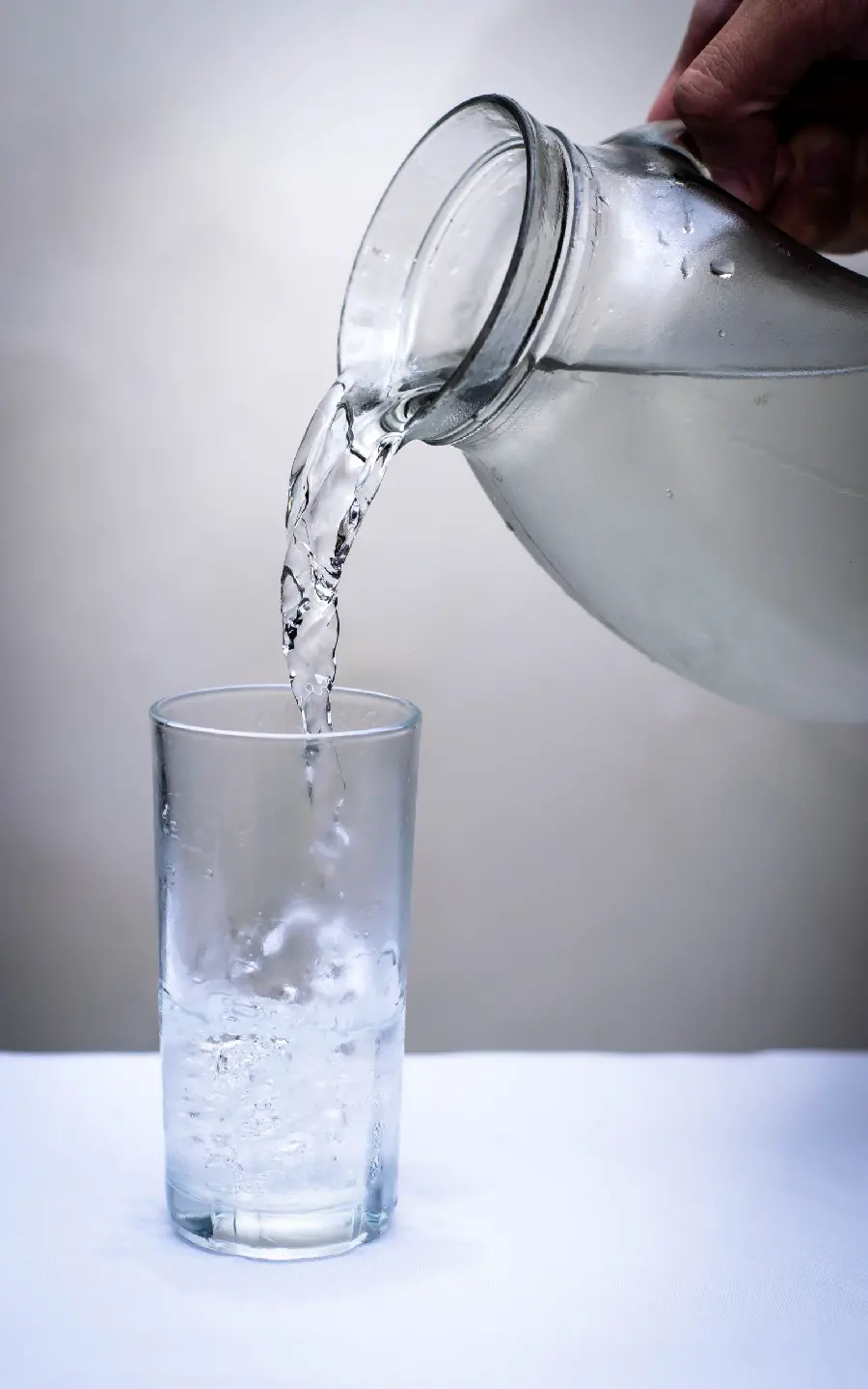 Download background image of a pitcher pouring very cold drinking water into a glass