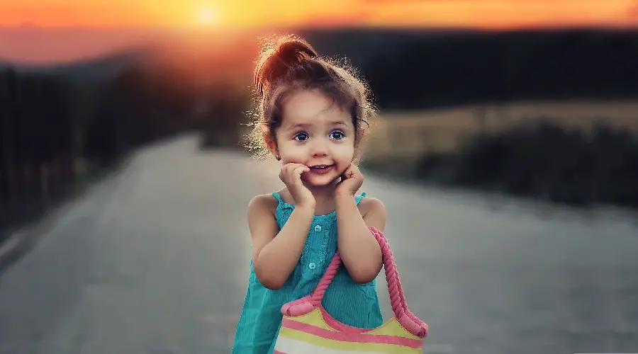 The cutest baby girl background with a cute face in a lovely sunset 