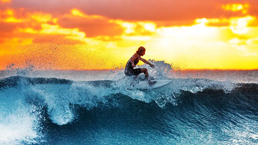 Surfing with fun in the sea at sunset