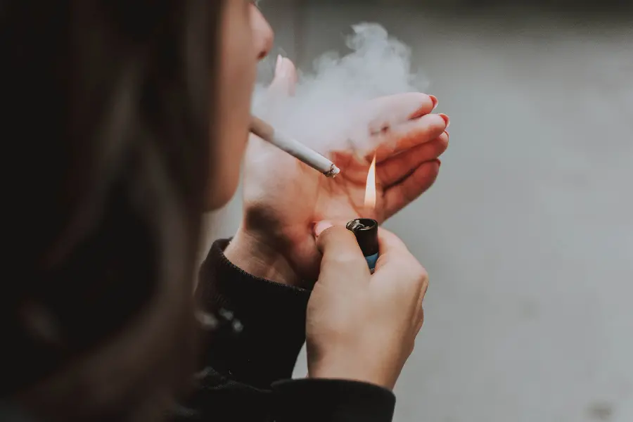 A special new laptop background of a girl with a lit lighter and a cigarette smoking device