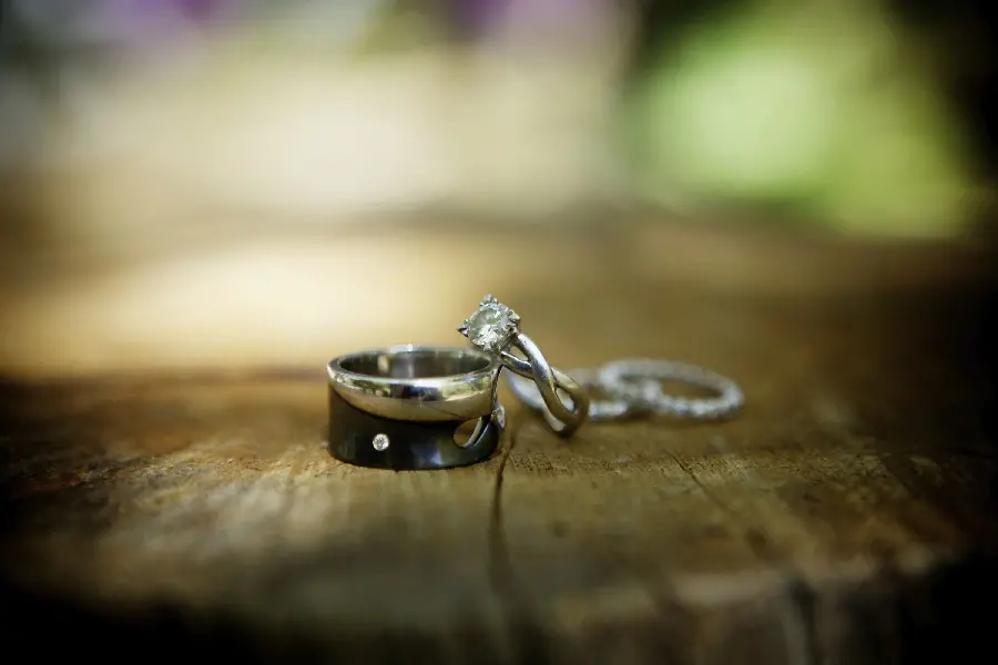 Download blurry background of silver rings suitable for weddings on a piece of wood