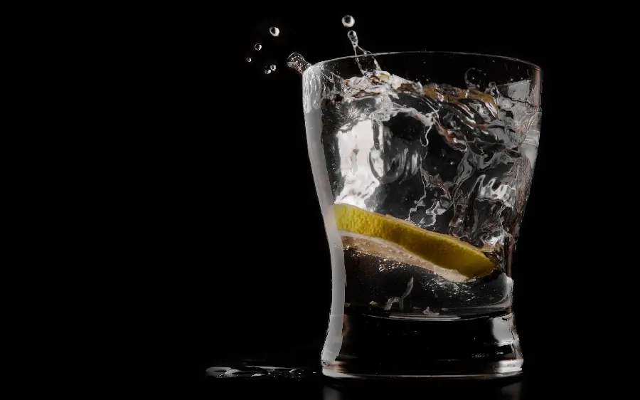 Download Black Stock Photo of Splitting Drinking Water Glass with Fresh Lemon Slice
