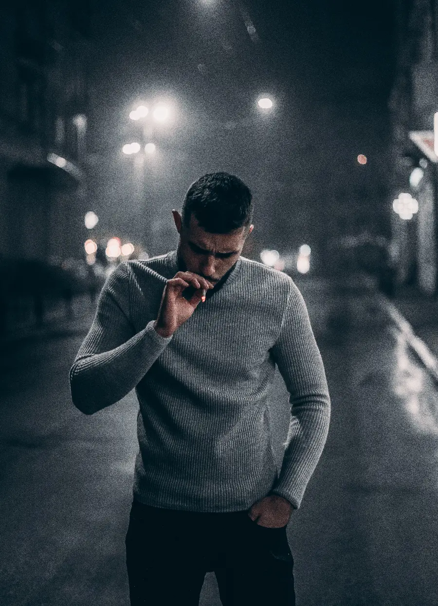 The classiest mobile wallpaper with a design of an attractive boy smoking under the rain