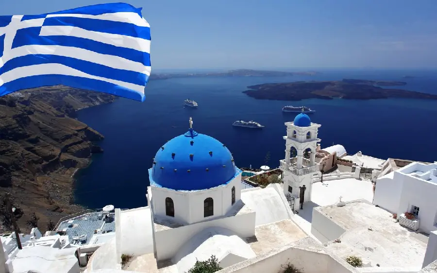 The most beautiful high-quality image of white houses and a blue flag on the island of Santorini