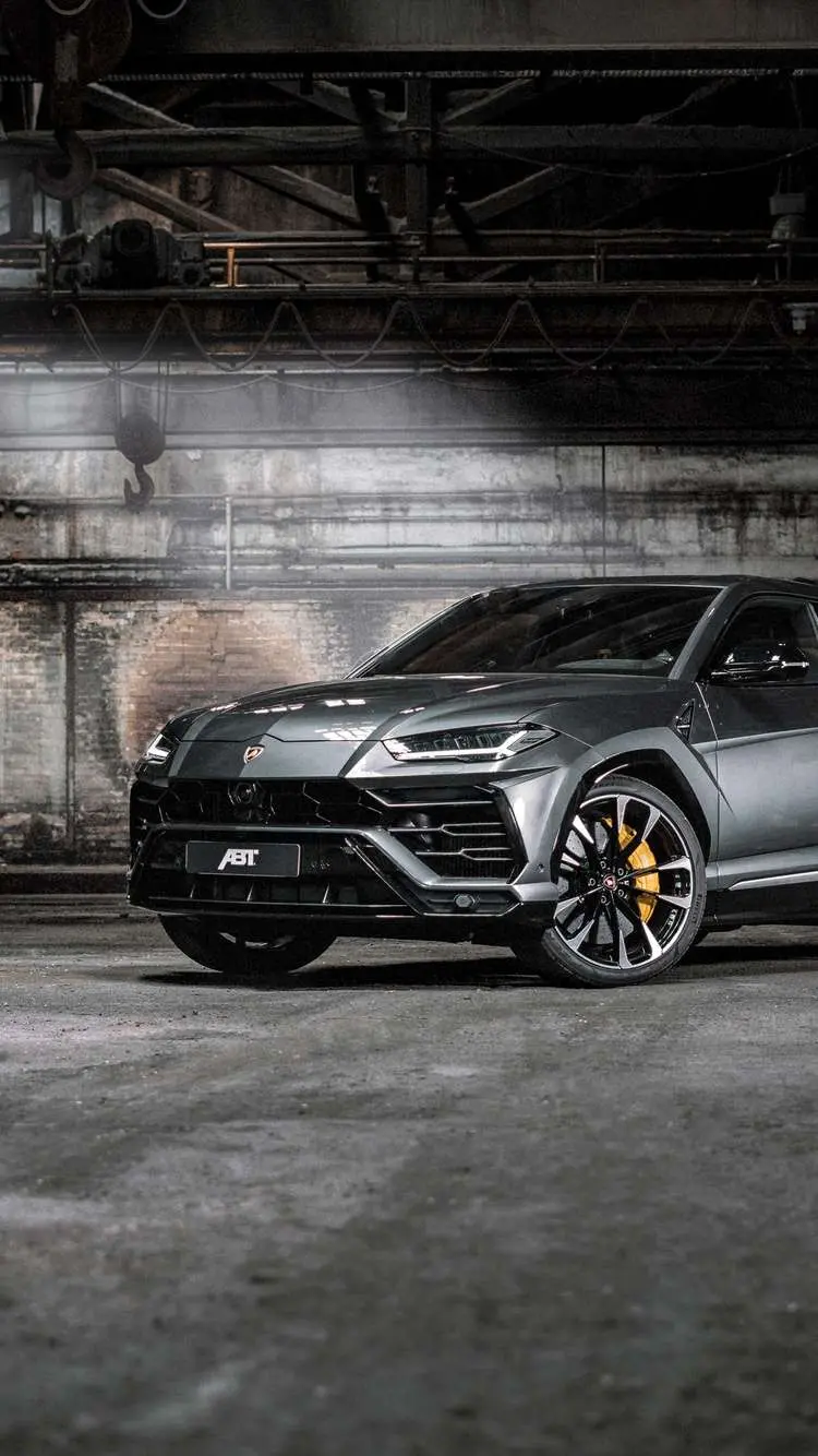 Black Lamborghini SUV Inside a Stylish Garage Suitable for Wallpaper