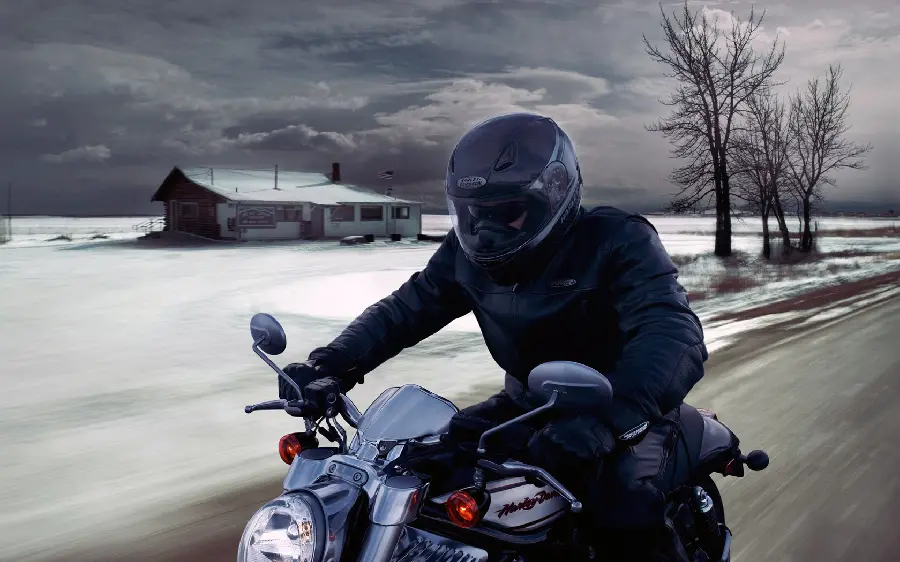 Attractive profile photo of a motorcyclist on a beautiful snowy road