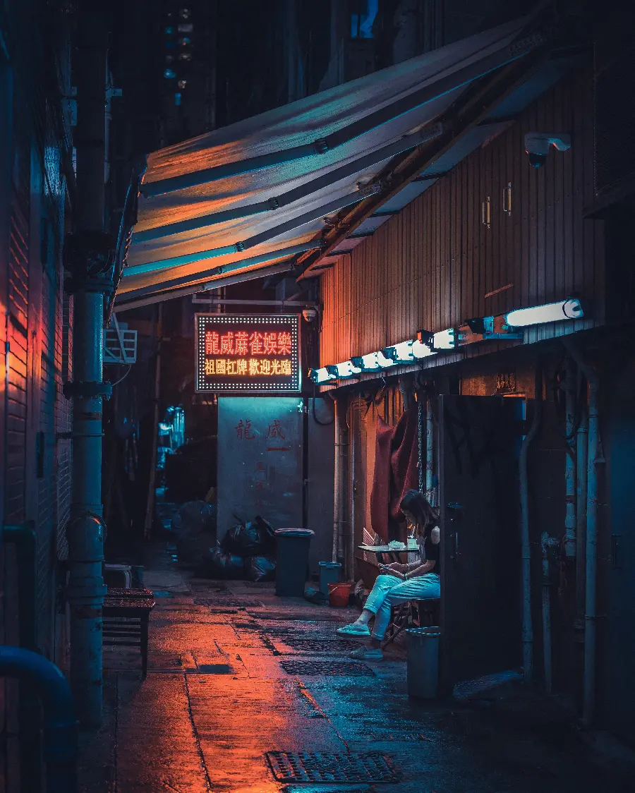Picture of a sad girl holding a phone in her hand on a lonely street