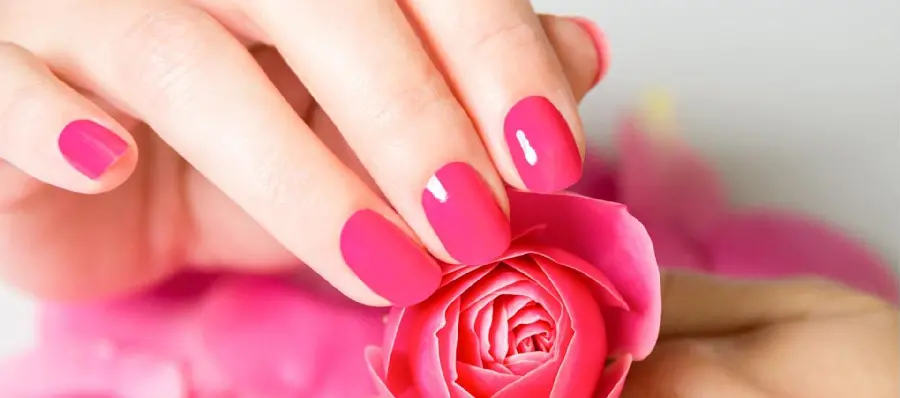 Short neat nail extension model in attractive magenta color for girls