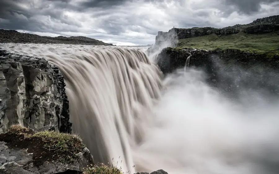 Interesting laptop background of nature with a large waterfall in full hd quality