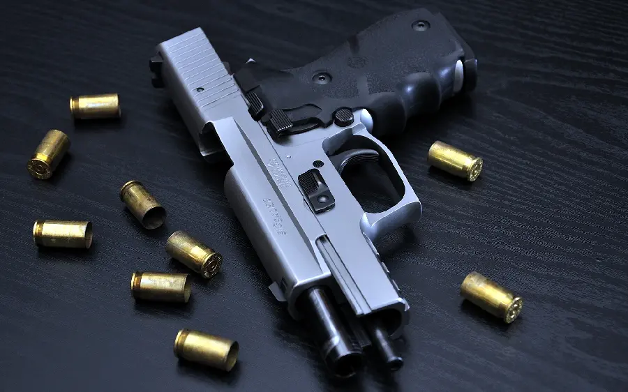 Download a quality photo of a rifle and a handgun With black background in jpg format