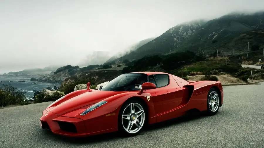 Spectacular image of a red sports car on the slopes of the mountains with excellent quality 