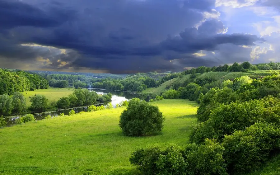 Green nature photo with cloudy sky for computer background