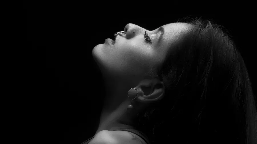 Black and white modeling photo of a beautiful girl with piercings for Instagram