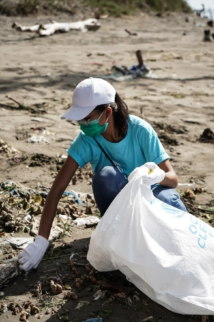 Photo of an environmentally friendly girl collecting garbage