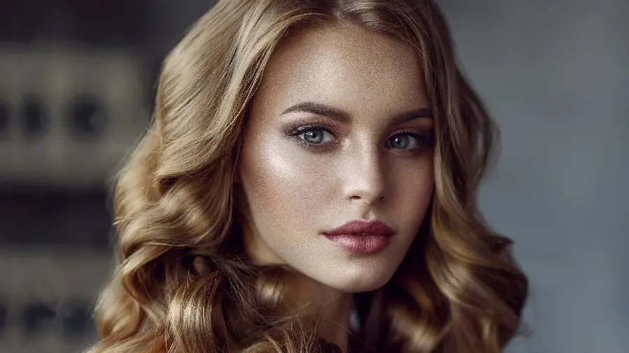 Full HD photo of a beautiful colored-eyed foreign girl with curly blonde hair