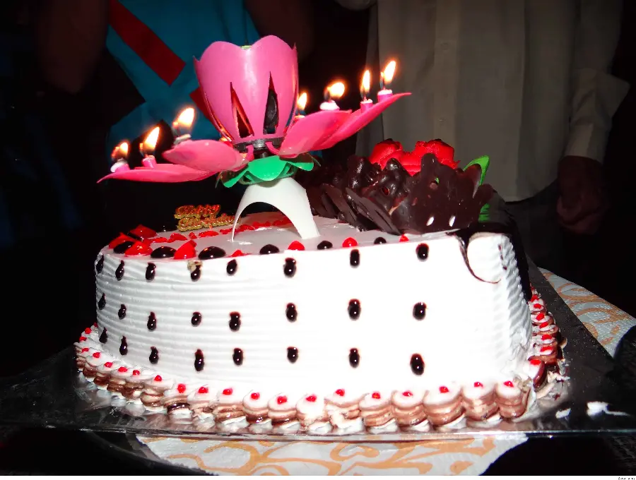 Stylish birthday cake image with pink pop-up candle in high quality