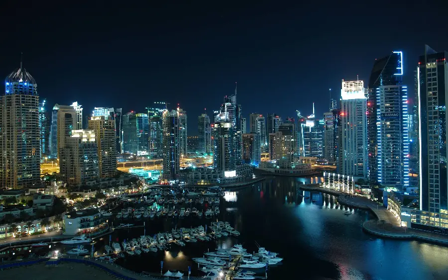Sparkling image of Dubai city at night with many sights