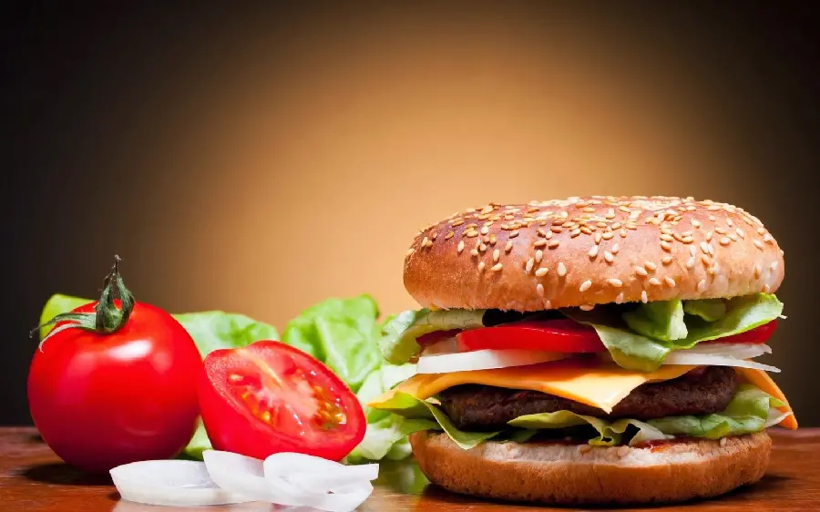 A delicious and tempting hamburger image with tomatoes and lettuce