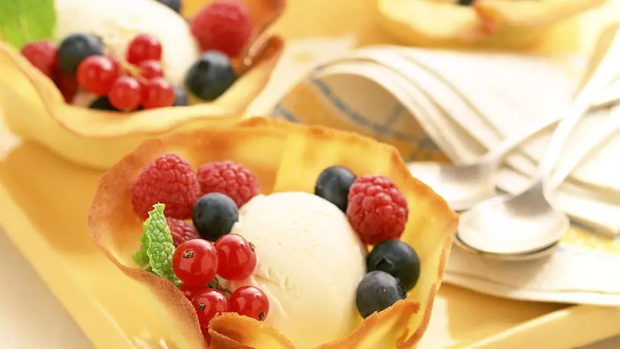A delicious summer dessert image decorated with blueberries and strawberries