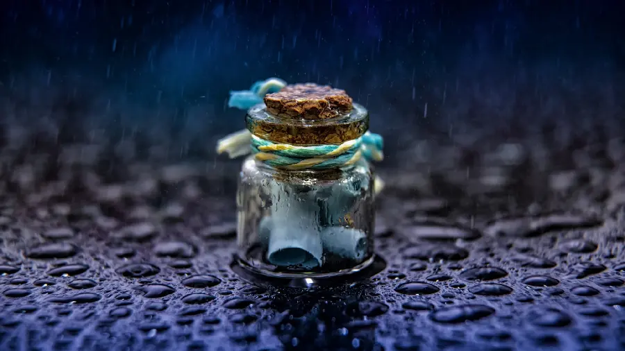 Beautiful wallpaper of a small glass with a letter inside it 