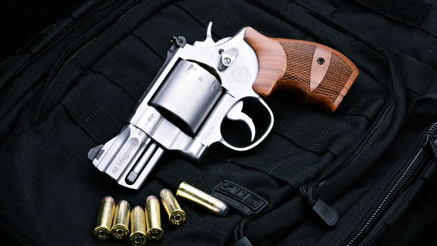 Image of a gun with a 9 mm bullet for wallpaper on a black background