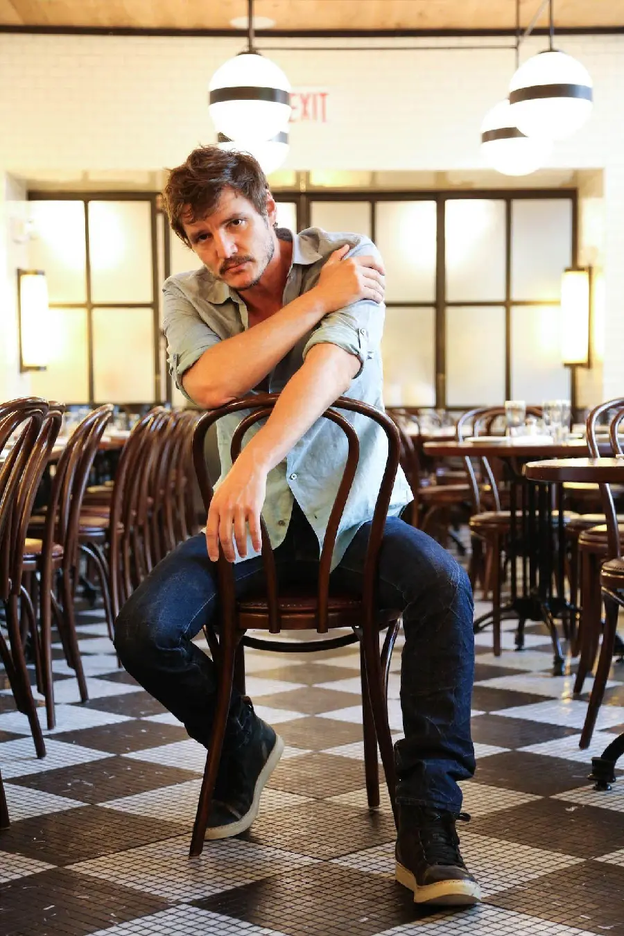 The most famous photo of Pedro Pascal on a chair for a profile