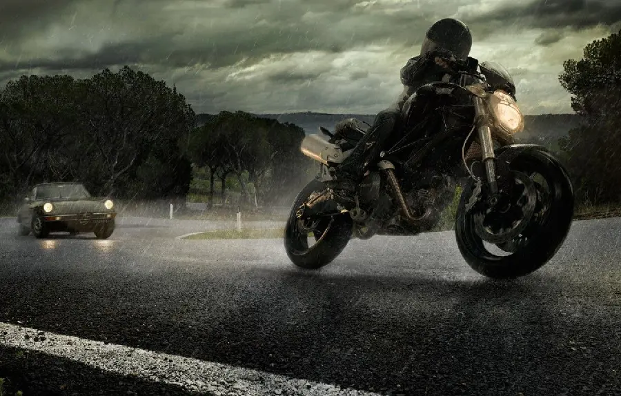 Beautiful picture of a motorbike and a car on a rainy road