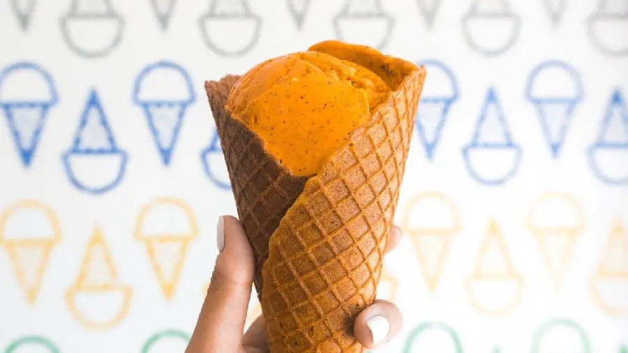 A very good quality photo of a yellow ice cream cone
