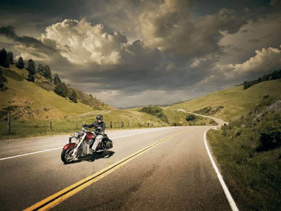 Photo of a pristine road and a motorbike