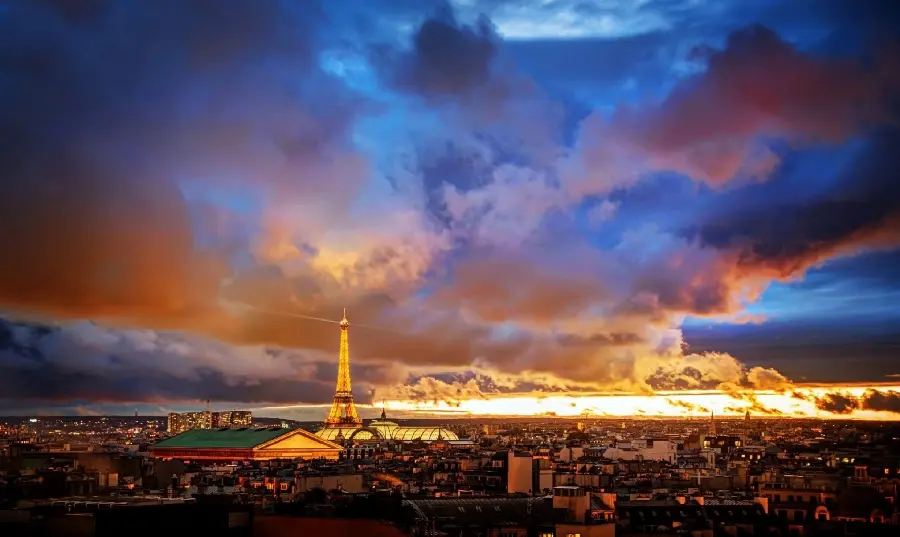 The most lovely photo of Paris, France under a colorful cloudy sky