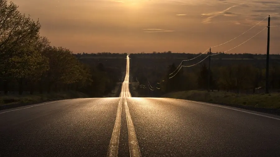 Wallpaper of a long road and sunset