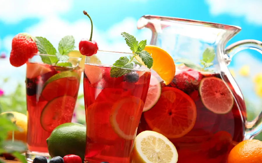 A cool summer drink in a hearty red color in a beautiful frame