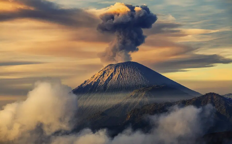 Download Background of a large volcanic mountain with dark ash smoke
