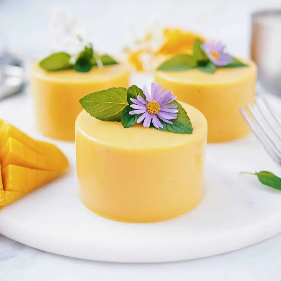 Download the incredibly beautiful image of a yellow mango dessert with a flower decoration for printing