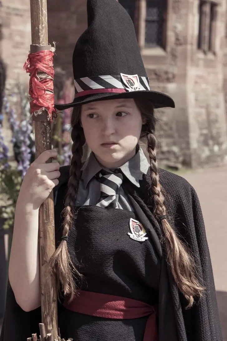 Bella Ramsey in the series The Worst Witch with a witch costume