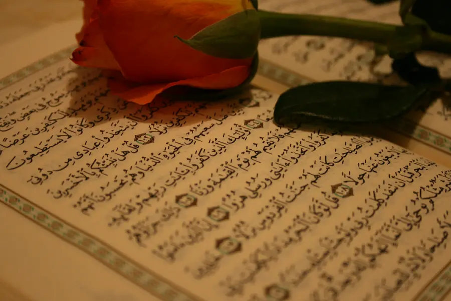 Super beautiful religious profile photo of flowers on the page of the Quran