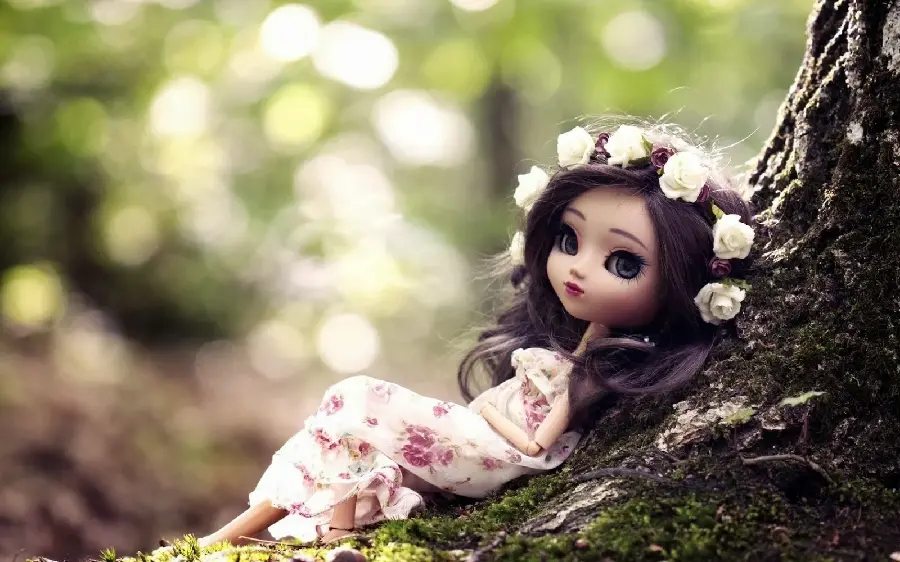 Beautiful girl doll photo leaning on a tree high quality