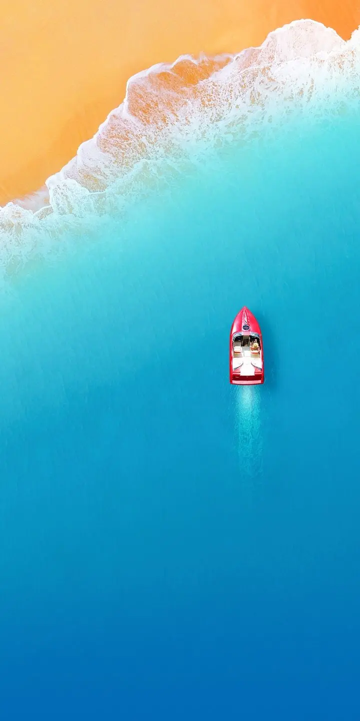 Photo of a luxury red boat in the sea from above as a Samsung wallpaper
