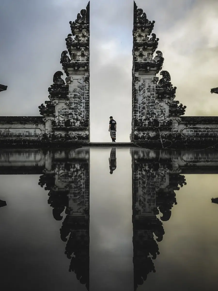 Interesting artistic frame of a man standing in the Pura Besaki Temple, Bali