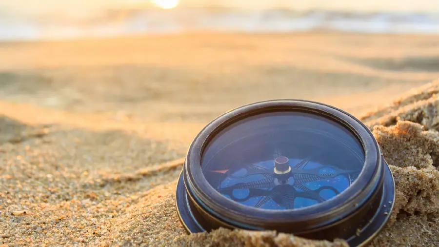 Unique Stock Photo of Compass on Sandy Beach 