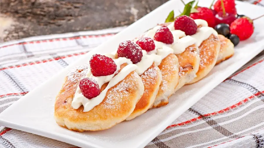 Homemade nutritious pancakes with tempting cream decoration