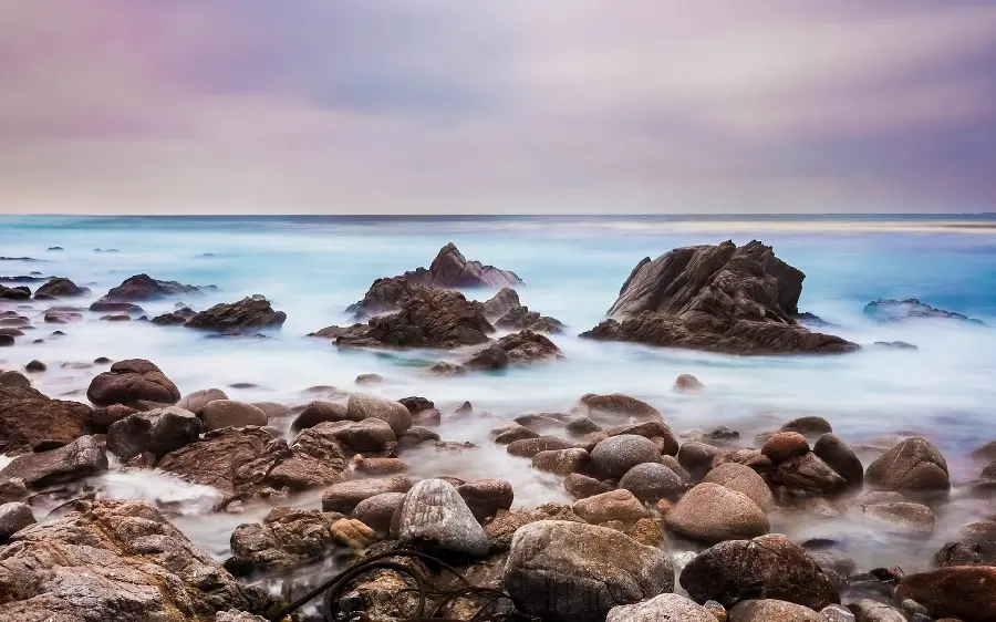 Spectacular backgroundLaptop with the image of a rocky seashore
