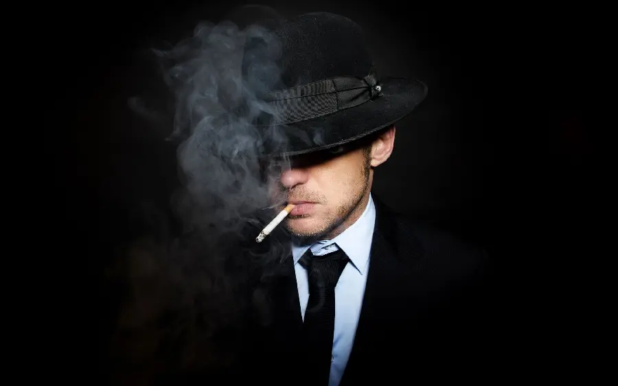 Profile photo of a smoking boy with a black background
