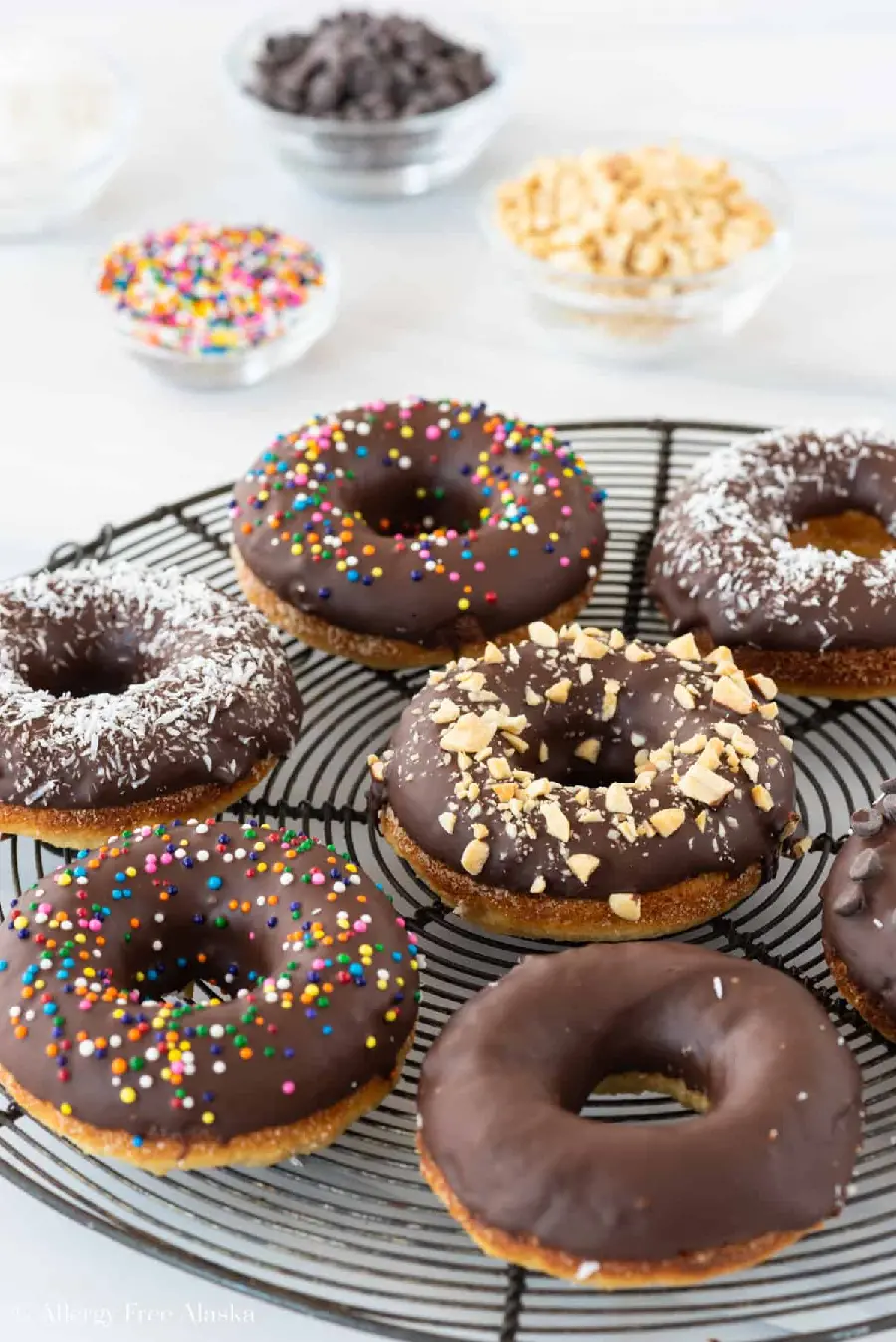 Photo of donuts decorated with coconut powder and colored truffles