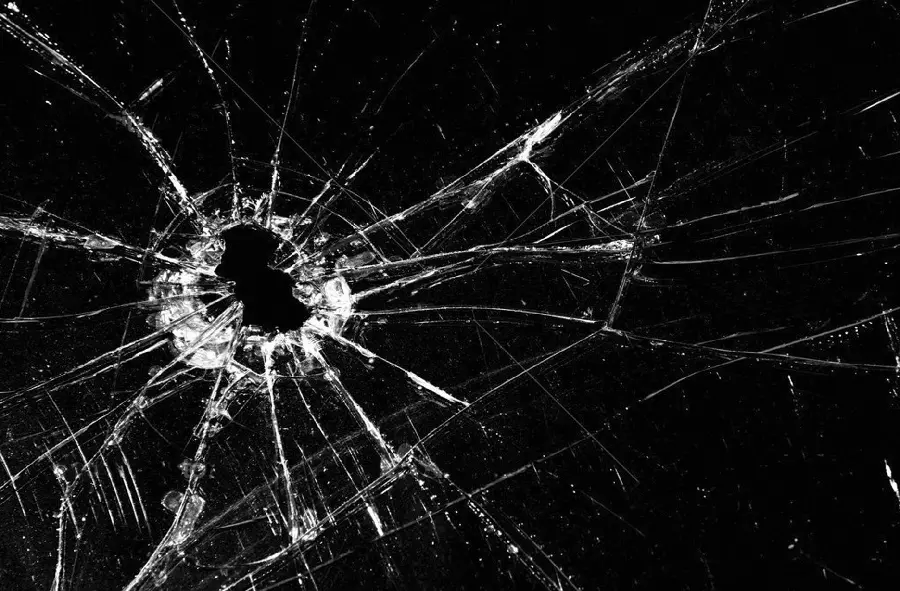 New background of bullet-ridden broken glass for the desktop of cool people