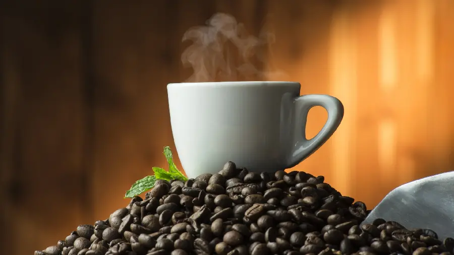Spectacular background of a cup on coffee beans in hd quality
