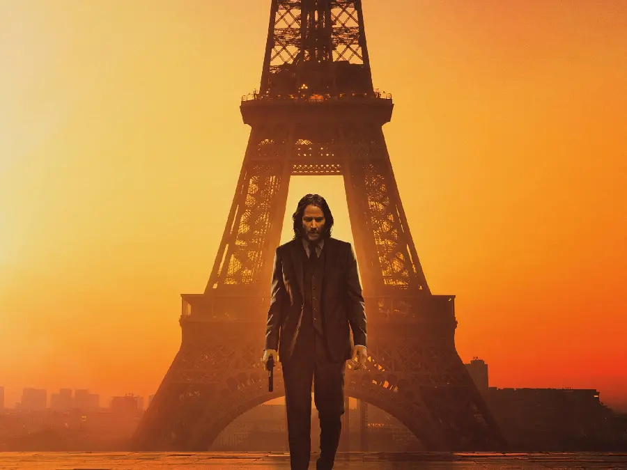 John Wick picture with a gun with the Eiffel Tower in the background in Paris